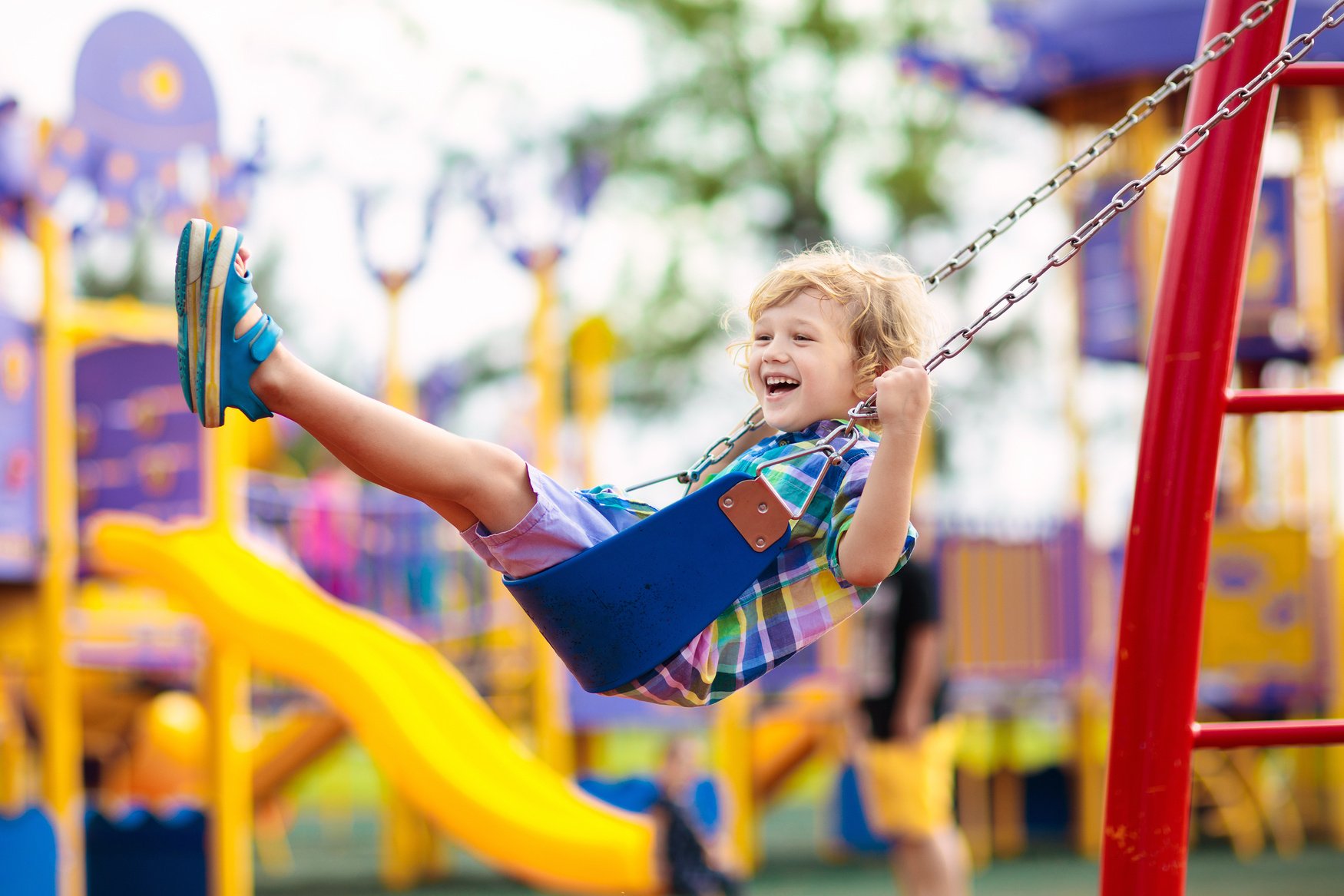 Child on playground. Kids play outdoor.